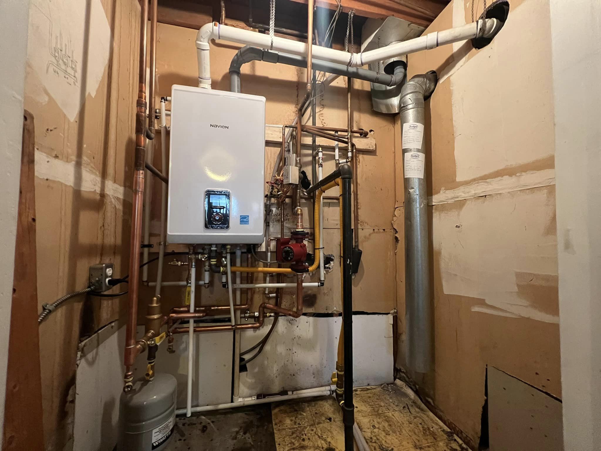 Technician completing **Water Heater Installation Burnaby** with clean piping and safety checks