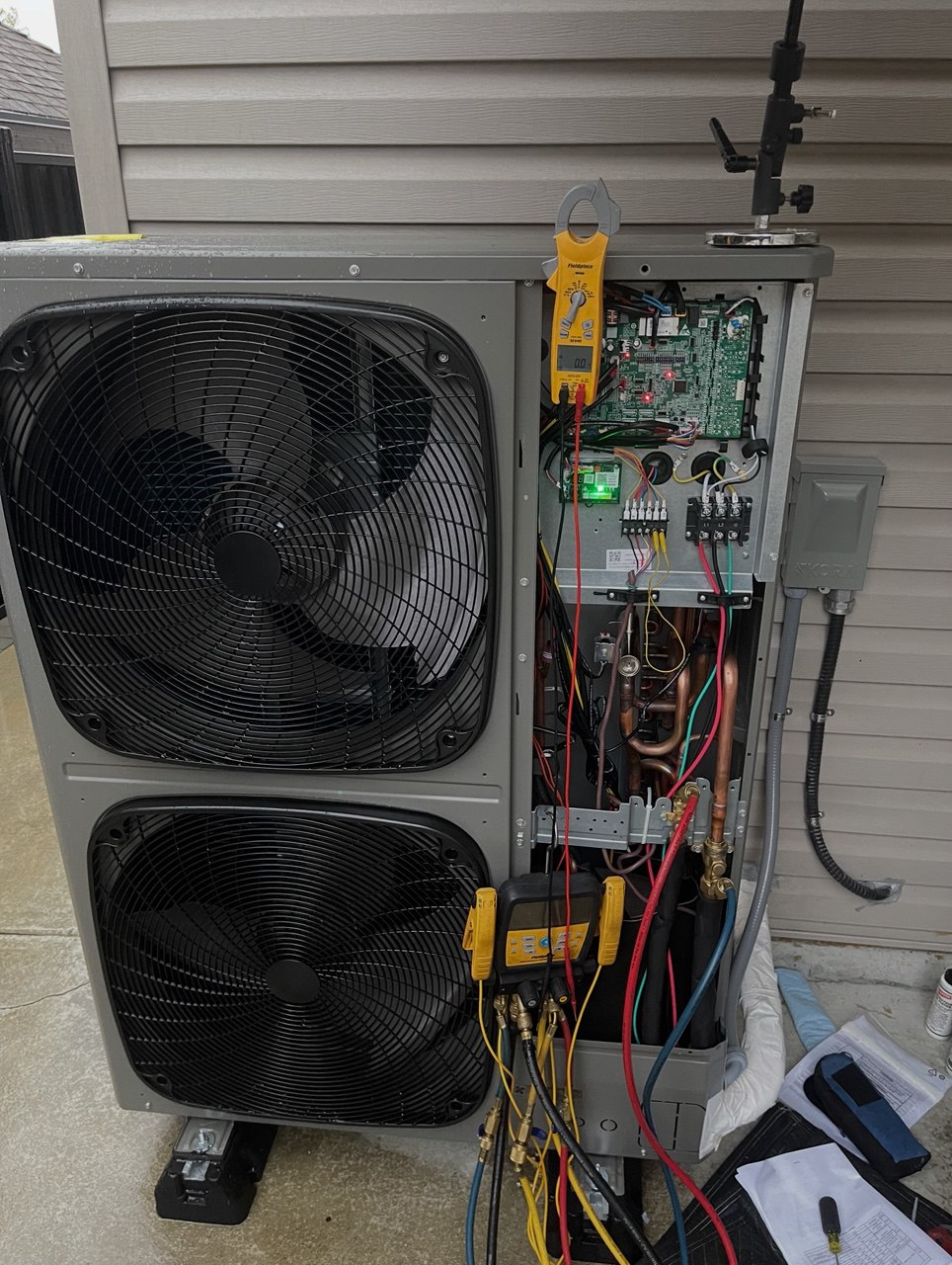 HVAC technician servicing AC and heat pump equipment