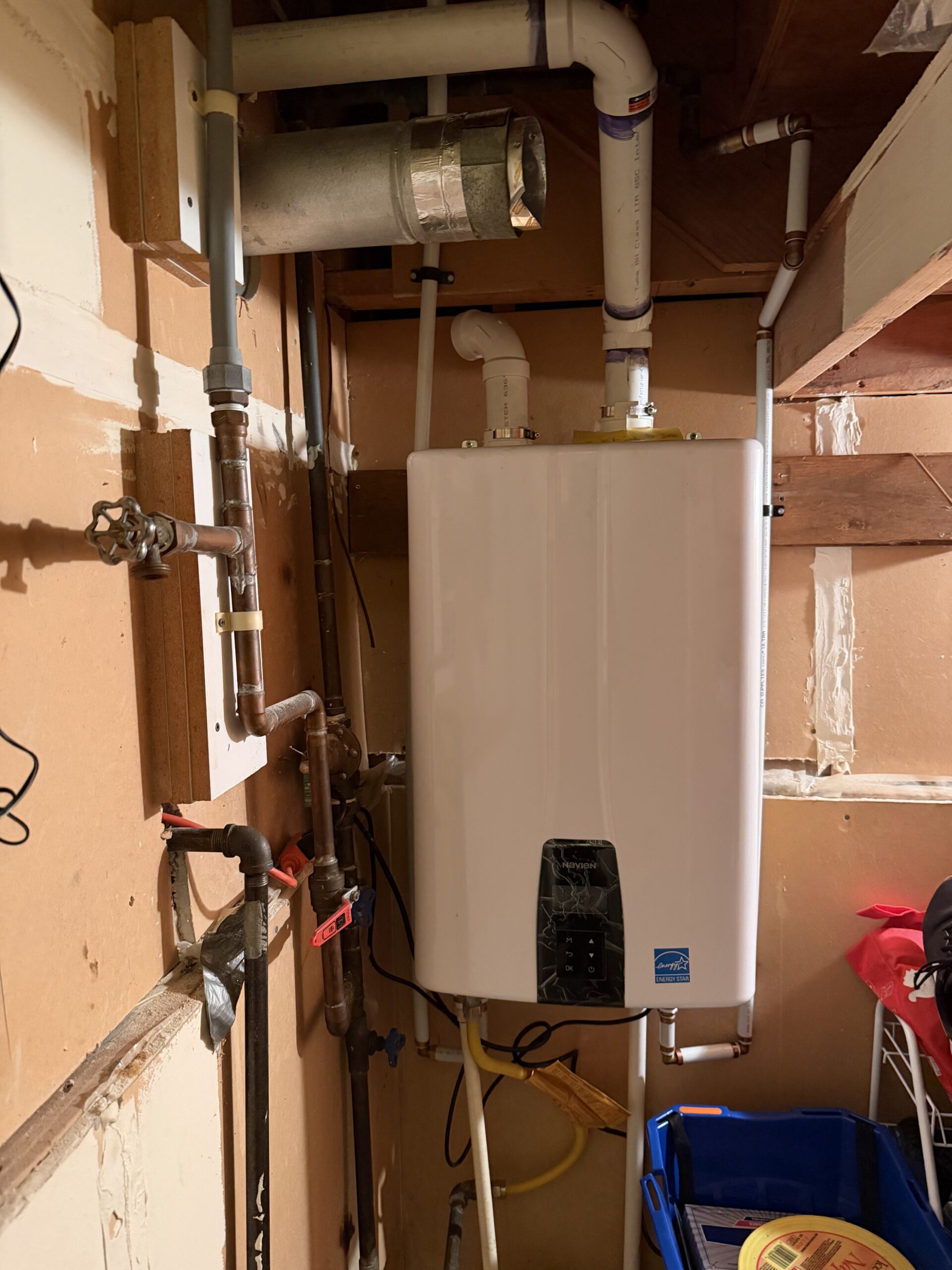 Tankless **Water Heater Installation Burnaby** with Navien unit mounted and piped neatly