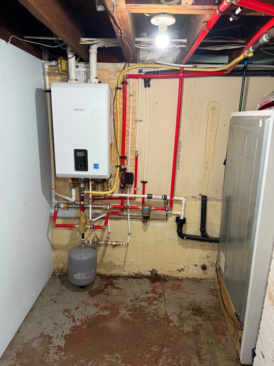 Navien combi boiler and hydronic connections reviewed during boiler service