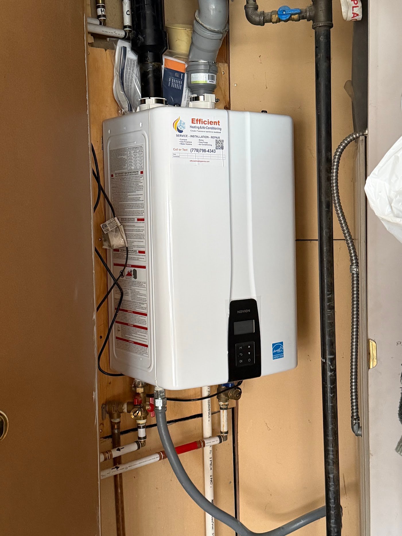 Wall-mounted Navien appliance and nearby connections used to explain boiler installation access planning