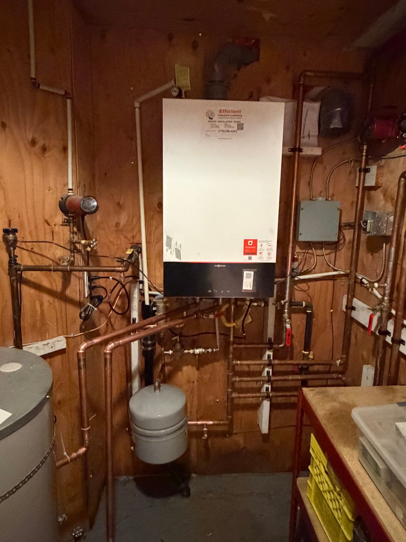 Wall-mounted Viessmann boiler with copper pipework, external circulators, expansion tank and adjacent storage tank