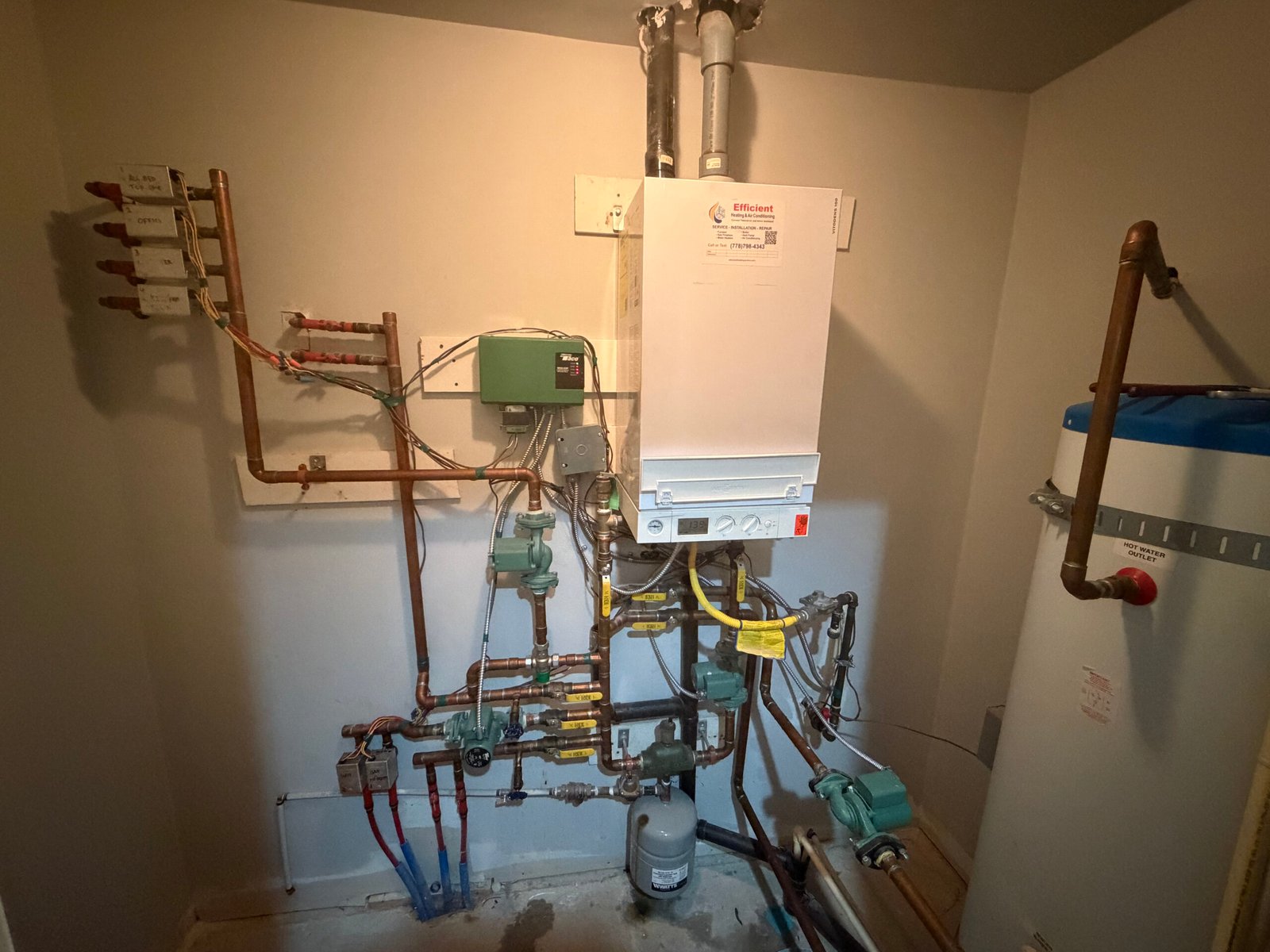 Viessmann Boiler and Hot Water System Project Viessmann wall-hung boiler connected to multi-zone hydronic piping and a hot water storage tank