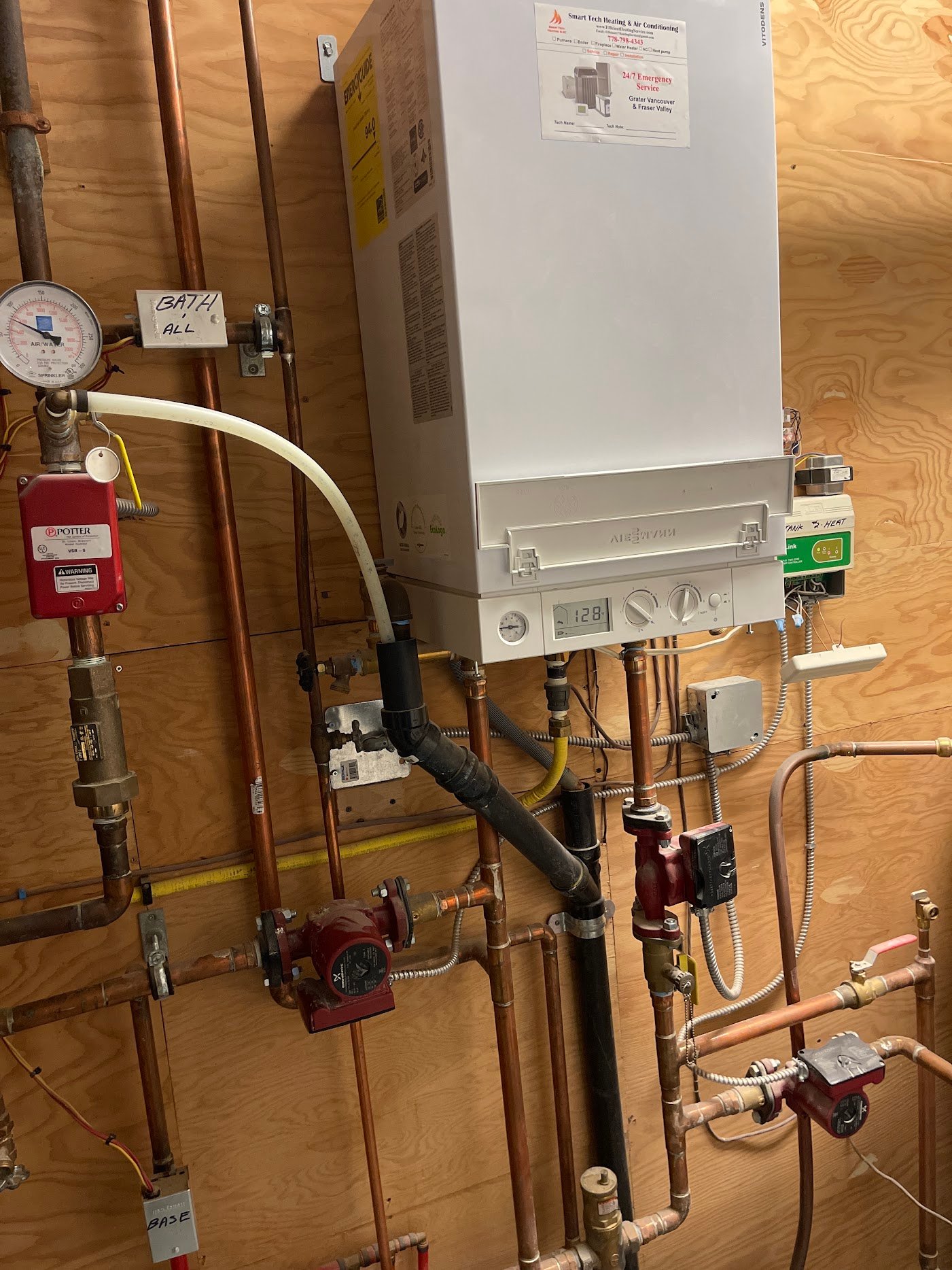 Existing boiler and external circulators — replacement scope Wall-mounted boiler with a pressure gauge, copper heating pipes and external circulator pumps