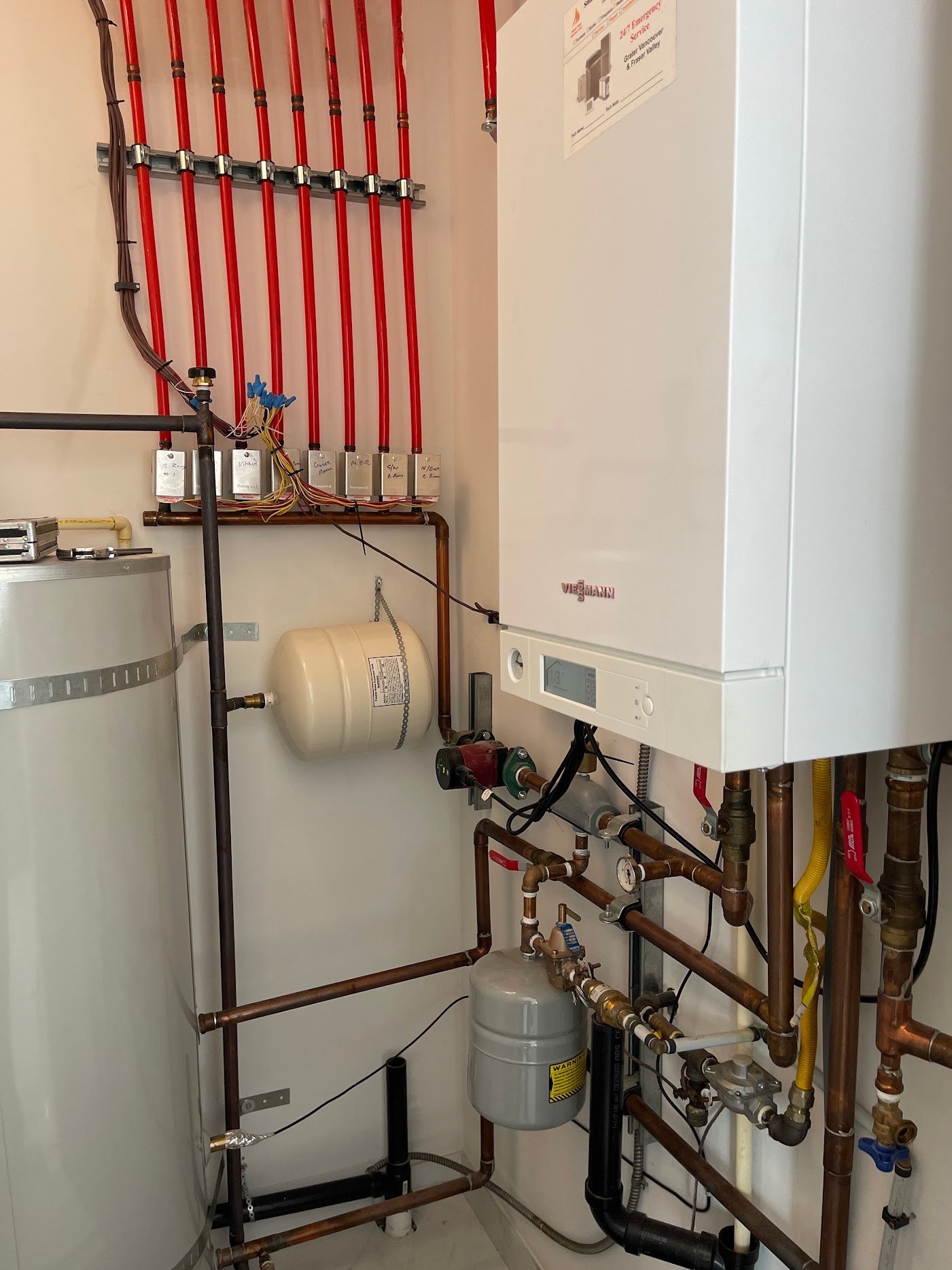 Viessmann boiler beside a separate hot-water tank, expansion vessel and radiant zone piping